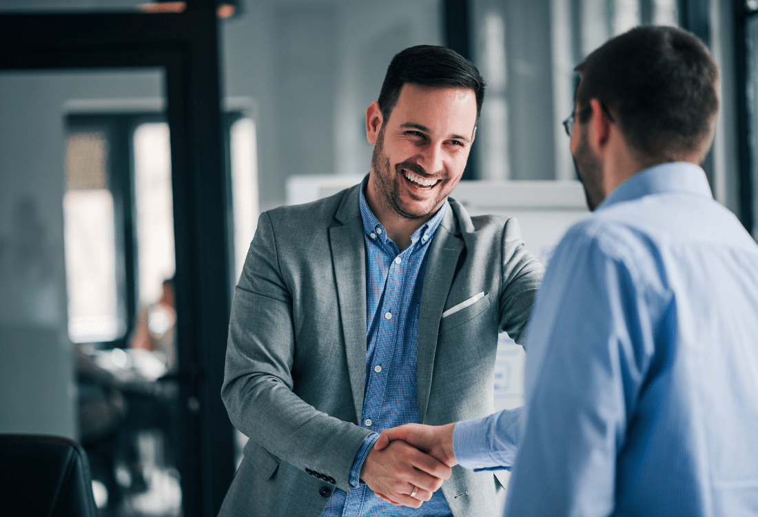 Two employees shaking hands representing how to manage different employees