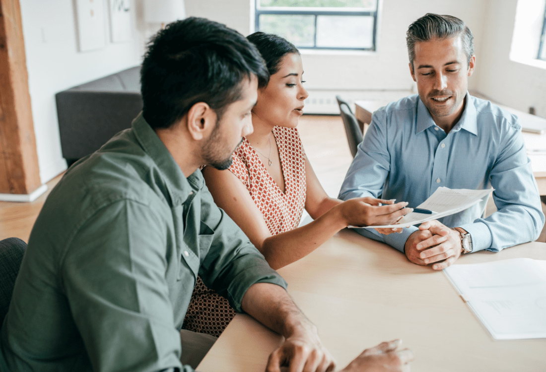 People sat around a table, discussing what a 360-degree appraisal is.  